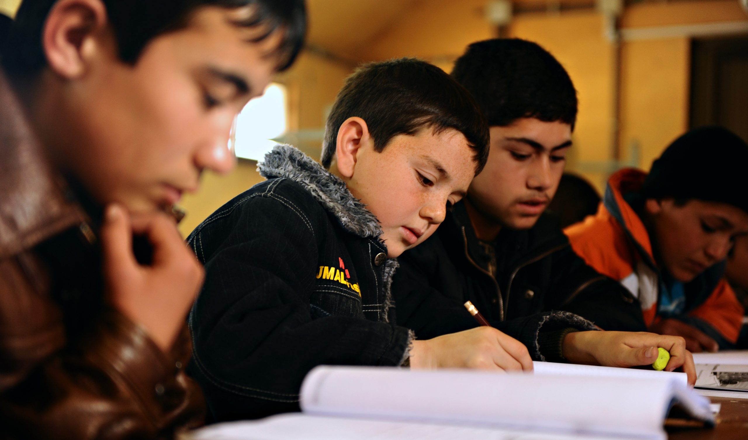 CAMP SHAHEEN, Afghanistan Ð Afghan students study English in a school outside Mazar-e-Sharif as part of an Afghan National Army initiative to increase literacy. A separate video-pen-pal initiative involved video taping the students for exchange with children of U.S. service members and other American students. (Photo by Master Sgt. Christopher DeWitt, USAF)